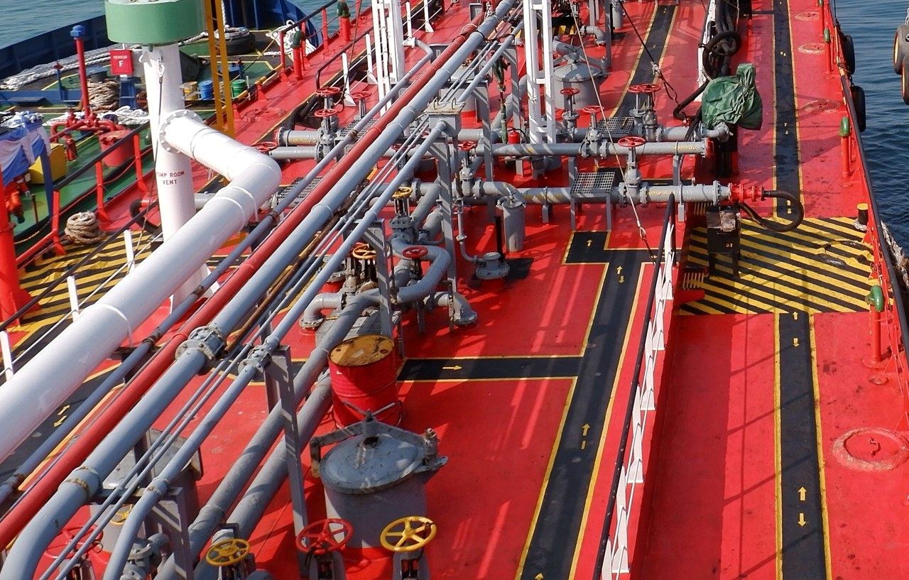 Working deck of a bunker tanker with manifold and hoses